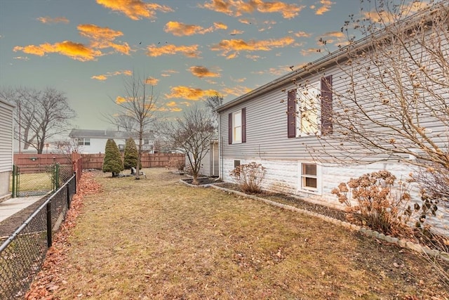 property exterior at dusk with a yard