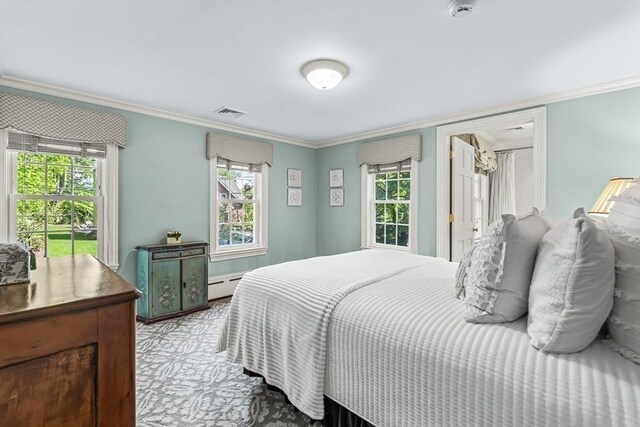 carpeted bedroom featuring a baseboard heating unit, ornamental molding, and multiple windows