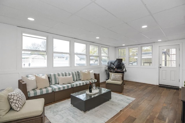 living area with recessed lighting, a drop ceiling, and dark wood-style floors