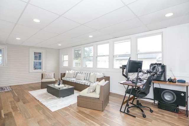 living room featuring a drop ceiling and wood finished floors