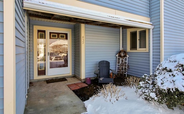 view of snow covered property entrance