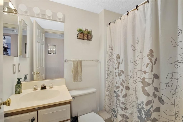 bathroom with vanity, a shower with shower curtain, a textured ceiling, and toilet