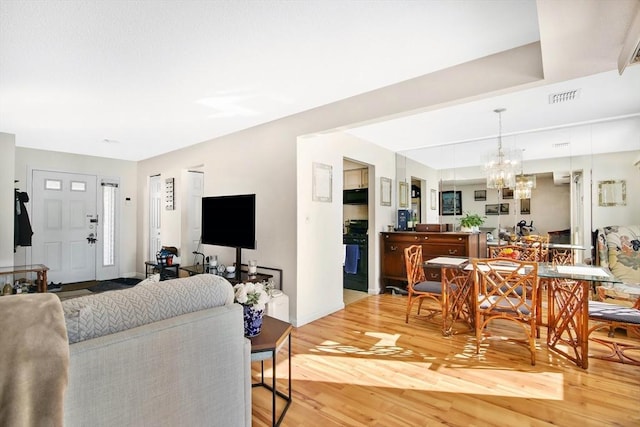 living room with hardwood / wood-style flooring and a chandelier