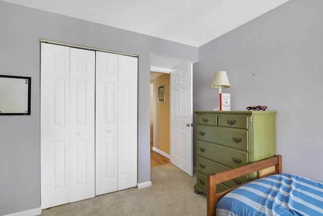 carpeted bedroom with a closet