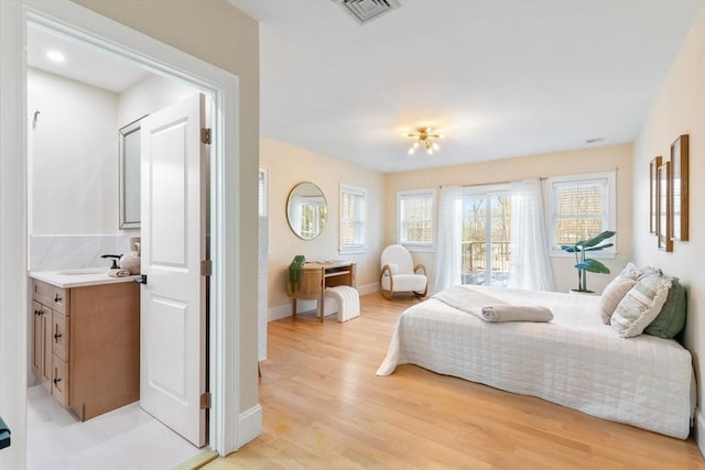 bedroom featuring access to exterior and light hardwood / wood-style floors