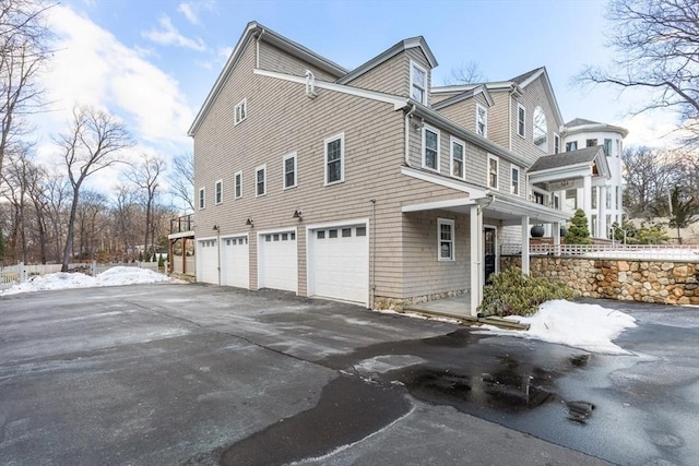 view of snowy exterior with a garage