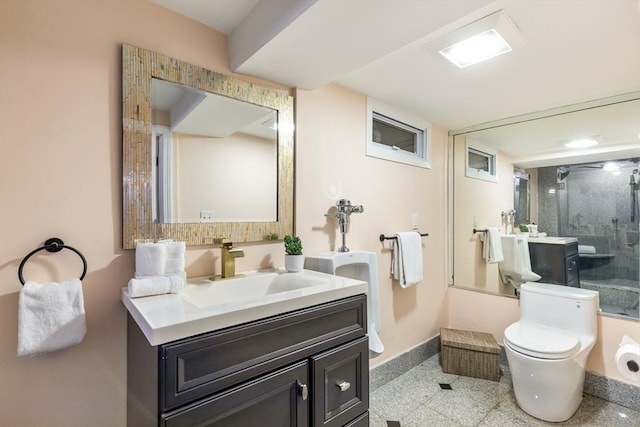 bathroom featuring walk in shower, vanity, and toilet