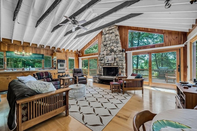 32 Pond Hill Rd, Goshen, MA 01032 - living area featuring wood finished floors, a stone fireplace, wooden walls, ceiling fan, and track lighting
