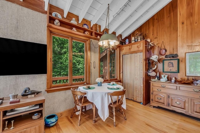 32 Pond Hill Rd, Goshen, MA 01032 - dining space with light wood-style flooring, a chandelier, and wood walls