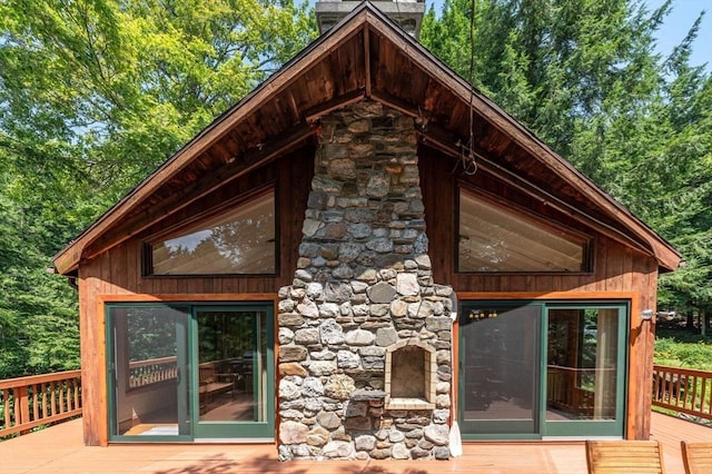 32 Pond Hill Rd, Goshen, MA 01032 - back of house with a wooden deck, stone siding, and a chimney