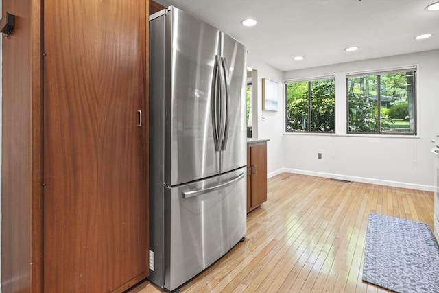 147 Butternut Holw Unit 147, Acton, MA 01718 - kitchen with freestanding refrigerator, light wood-style floors, baseboards, recessed lighting, and brown cabinetry