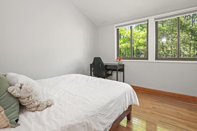 147 Butternut Holw Unit 147, Acton, MA 01718 - bedroom with multiple windows, hardwood / wood-style flooring, vaulted ceiling, and baseboards