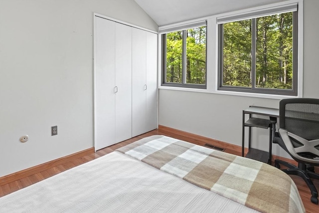 147 Butternut Holw Unit 147, Acton, MA 01718 - bedroom with vaulted ceiling, a desk, a closet, baseboards, and wood finished floors