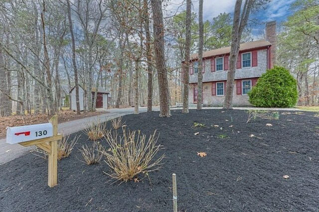 130 Surrey Ln, Brewster, MA 02631 - view of front of home featuring a chimney and an outbuilding