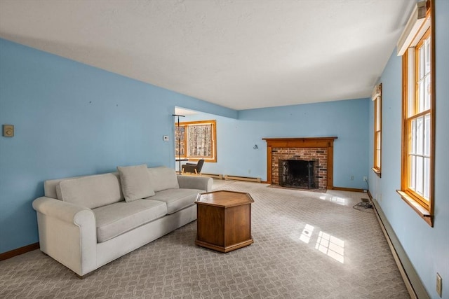 130 Surrey Ln, Brewster, MA 02631 - carpeted living area with a baseboard heating unit, baseboards, a brick fireplace, and a wealth of natural light