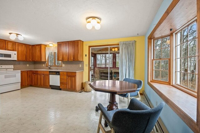 130 Surrey Ln, Brewster, MA 02631 - kitchen featuring brown cabinets, backsplash, white appliances, and light countertops