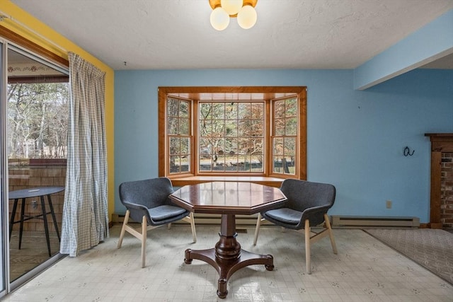 130 Surrey Ln, Brewster, MA 02631 - living area with a baseboard heating unit, a textured ceiling, a healthy amount of sunlight, and tile patterned floors