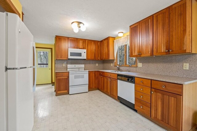 130 Surrey Ln, Brewster, MA 02631 - kitchen with light countertops, white appliances, a sink, and brown cabinets