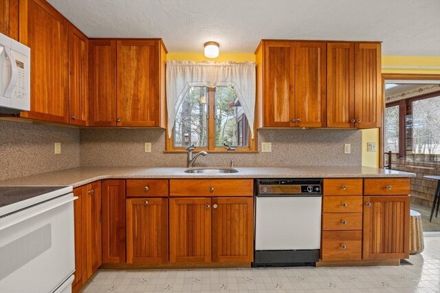 130 Surrey Ln, Brewster, MA 02631 - kitchen featuring light floors, a healthy amount of sunlight, a sink, and white appliances