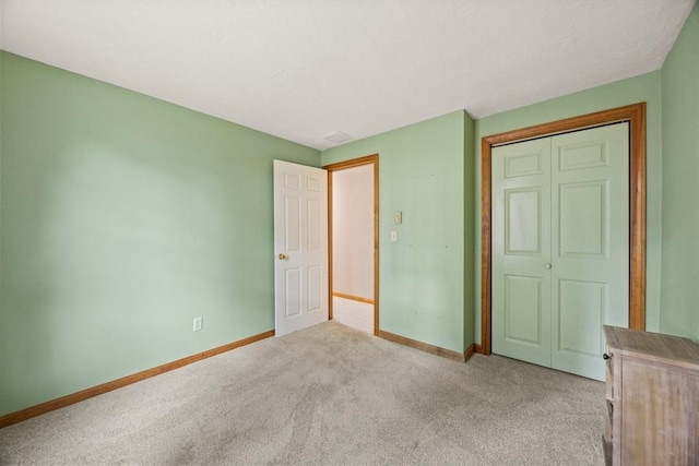130 Surrey Ln, Brewster, MA 02631 - unfurnished bedroom featuring baseboards, a closet, and light carpet
