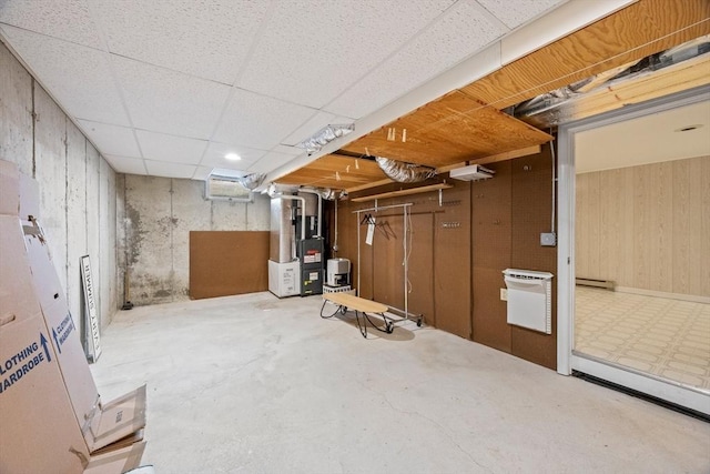 130 Surrey Ln, Brewster, MA 02631 - unfinished basement featuring heating unit, a baseboard radiator, and a drop ceiling
