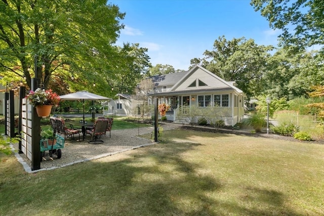 rear view of house with a yard and a patio area