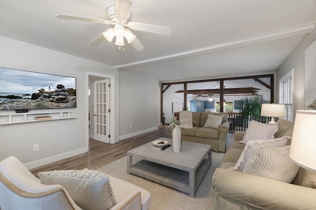 living room featuring light wood-type flooring and ceiling fan