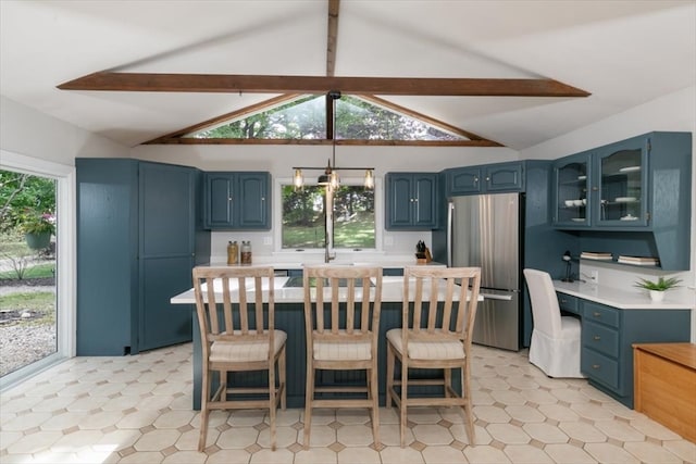 dining area featuring an inviting chandelier, beam ceiling, high vaulted ceiling, and a healthy amount of sunlight