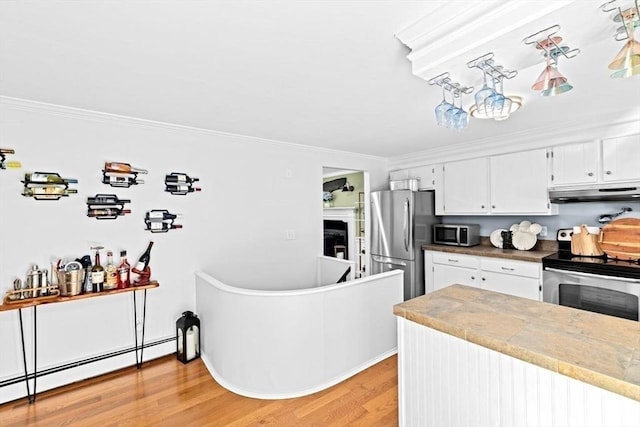 15 Surrey Ln, Sandwich, MA 02563 - kitchen with appliances with stainless steel finishes, baseboard heating, under cabinet range hood, ornamental molding, and light wood finished floors