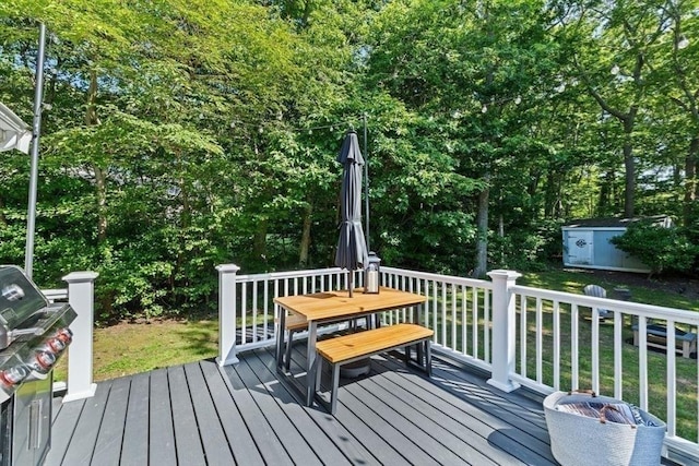 15 Surrey Ln, Sandwich, MA 02563 - wooden terrace with a storage unit, grilling area, outdoor dining area, and a lawn