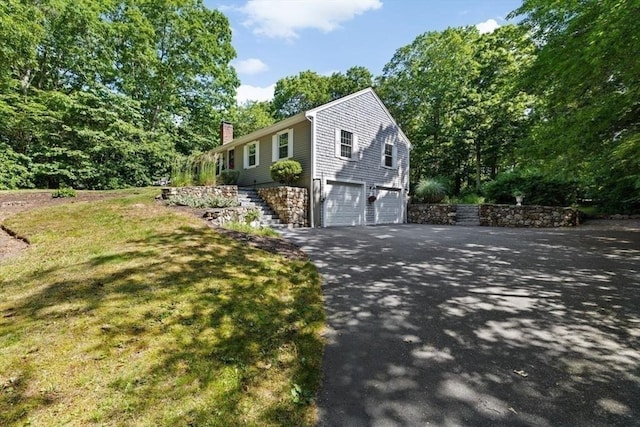15 Surrey Ln, Sandwich, MA 02563 - view of front of home with driveway, a garage, a chimney, stairway, and a front yard