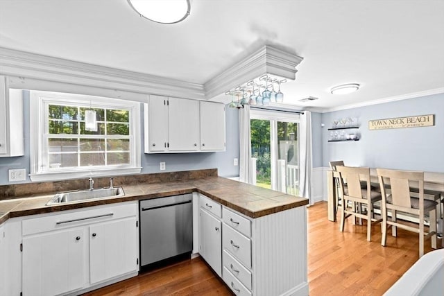 15 Surrey Ln, Sandwich, MA 02563 - kitchen with dishwasher, ornamental molding, a peninsula, white cabinetry, and healthy amount of natural light