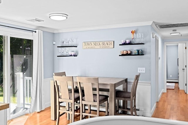 15 Surrey Ln, Sandwich, MA 02563 - dining space featuring ornamental molding, baseboard heating, light wood-type flooring, and healthy amount of natural light