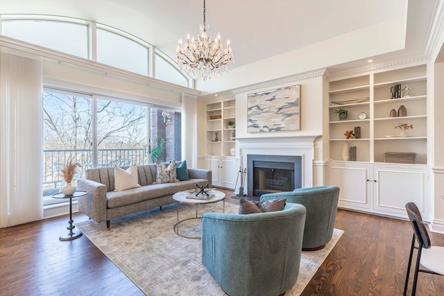 living room with a notable chandelier, built in features, and dark hardwood / wood-style flooring