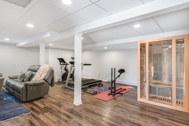 exercise room featuring a drop ceiling, wood finished floors, and recessed lighting