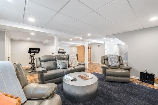 living area with recessed lighting, baseboards, and wood finished floors