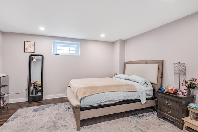 bedroom with baseboards, wood finished floors, and recessed lighting