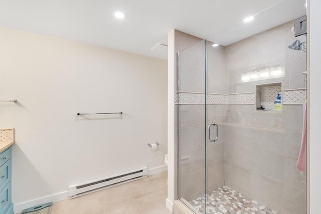 bathroom with a stall shower, toilet, a baseboard radiator, tile patterned floors, and vanity