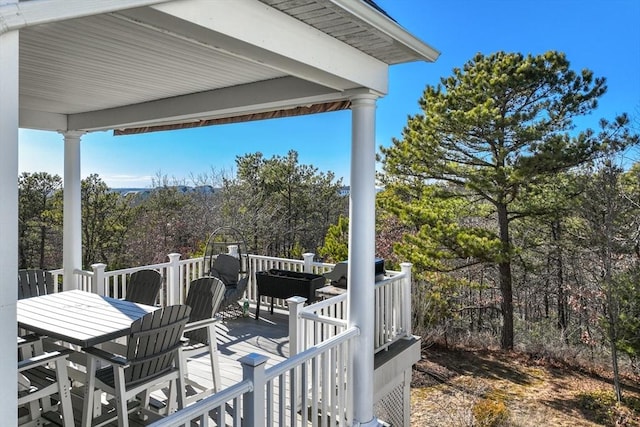 wooden deck featuring outdoor dining area