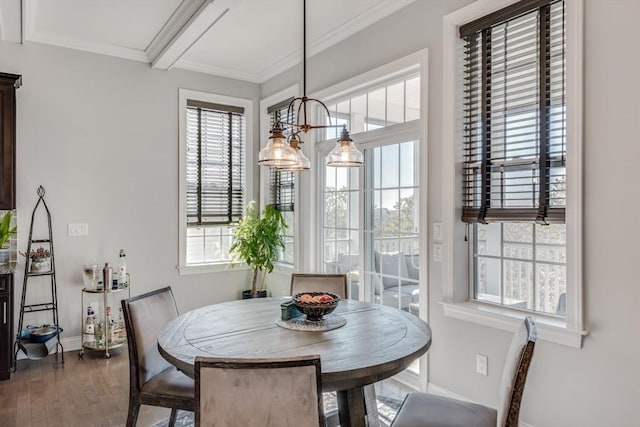 dining area with baseboards, wood finished floors, and crown molding