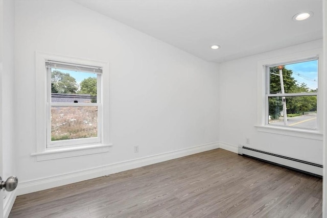 7 New Bridge St, Hingham, MA 02043 - spare room featuring healthy amount of natural light, a baseboard radiator, wood finished floors, and recessed lighting