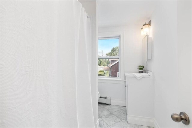 7 New Bridge St, Hingham, MA 02043 - full bath with a baseboard heating unit, toilet, baseboards, and a shower with shower curtain