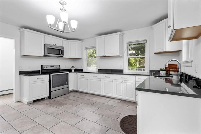 7 New Bridge St, Hingham, MA 02043 - kitchen with appliances with stainless steel finishes, a sink, dark countertops, and white cabinets