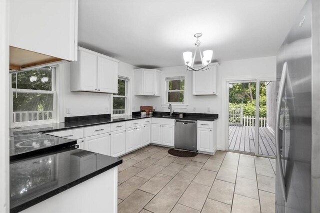 7 New Bridge St, Hingham, MA 02043 - kitchen featuring appliances with stainless steel finishes, white cabinetry, dark countertops, and a chandelier