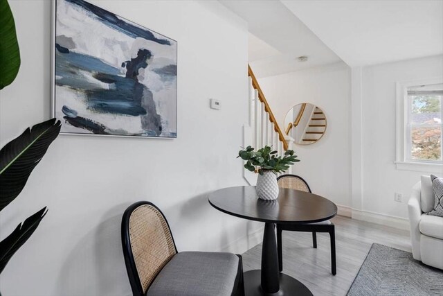 7 New Bridge St, Hingham, MA 02043 - sitting room featuring light wood-type flooring, stairway, and baseboards