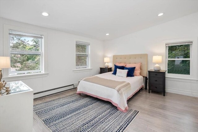 7 New Bridge St, Hingham, MA 02043 - bedroom featuring a baseboard radiator, multiple windows, light wood finished floors, recessed lighting, and baseboards