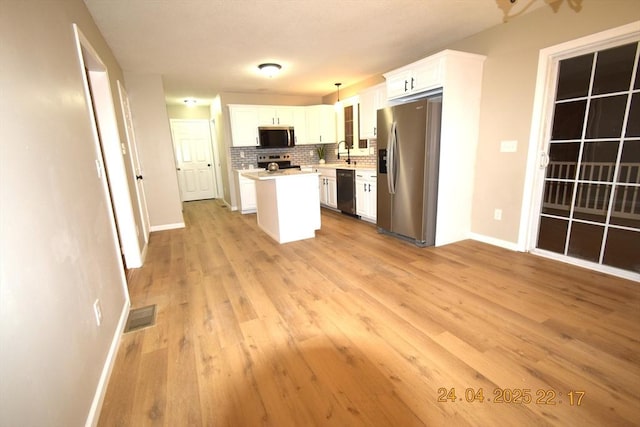 kitchen with visible vents, appliances with stainless steel finishes, light countertops, baseboards, and white cabinets