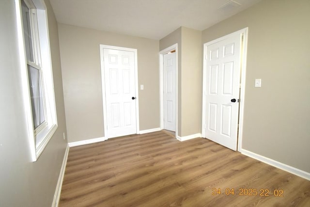 interior space featuring baseboards and wood finished floors