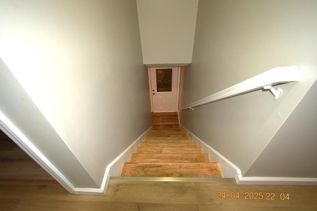 stairs with baseboards and wood finished floors