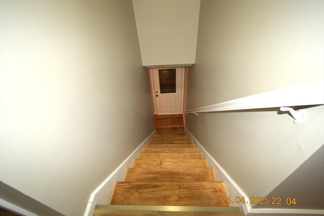 stairs with baseboards and wood finished floors